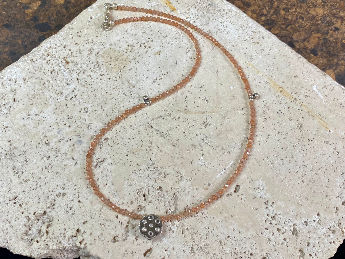 Natural clear pink/orange sunstone bead necklace with a beautiful old Indian silver pendant as the centrepiece. Silver bead detailing and a silver lobster clasp complete the look. Length 41.8 cm