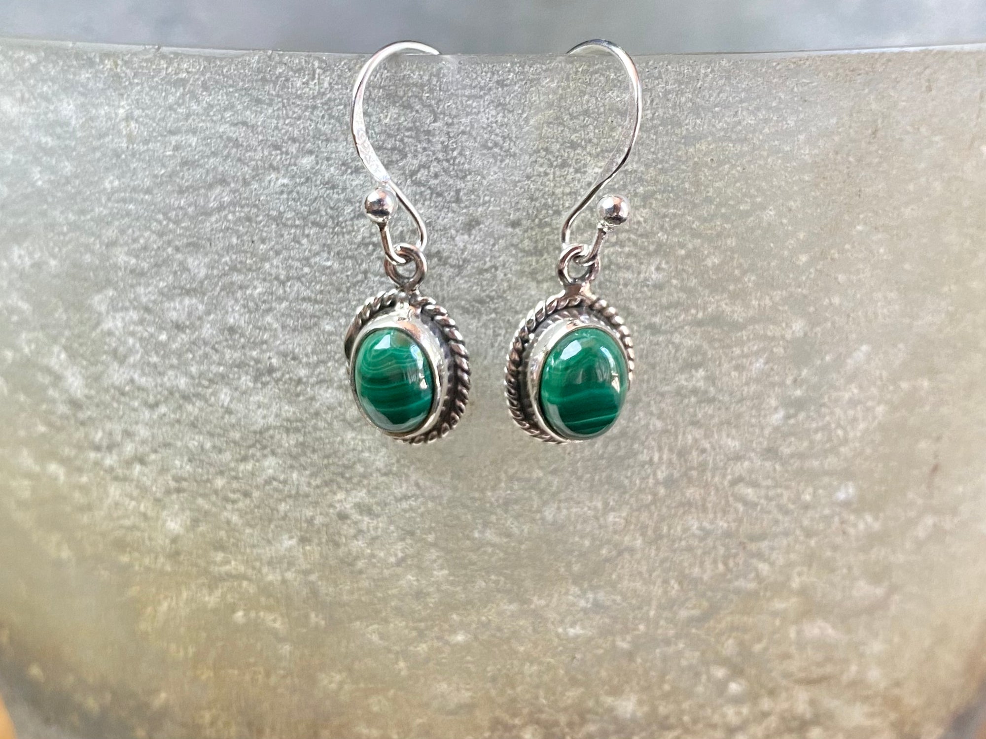 Elegant oval shaped earrings with a beautifully detailed bezel to show off the natural beauty of the cabochon stones. Sterling silver hooks complete the look. Our earrings are open-backed to allow natural light to show through. Length including hook 2.5 cm