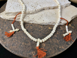 Women or men’s mala necklace. Made from buffalo bone, 108 beads and two spacers in the form of the bell and the dorje, symbols of Avalokiteshvara, the Compassionate Buddha.  Total length 64 cm. Fits easily over the head. Bone beads 5 mm diameter