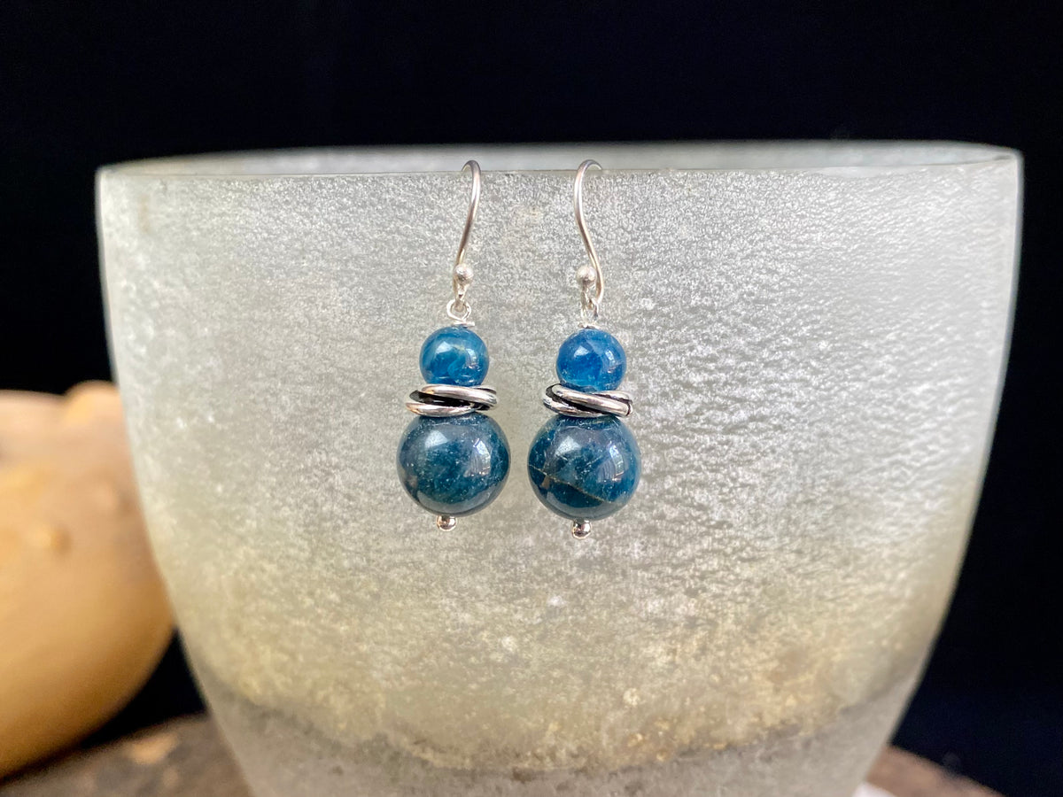 Simple, elegant apatite earrings featuring natural blue, graduated beads, finished with sterling silver detailing and hooks.   Apatite earring featuring sterling silver decoration 925 sterling silver shepherd hooks high quality natural stones light and easy to wear  Measurements: 3.3 cm  height including hook 