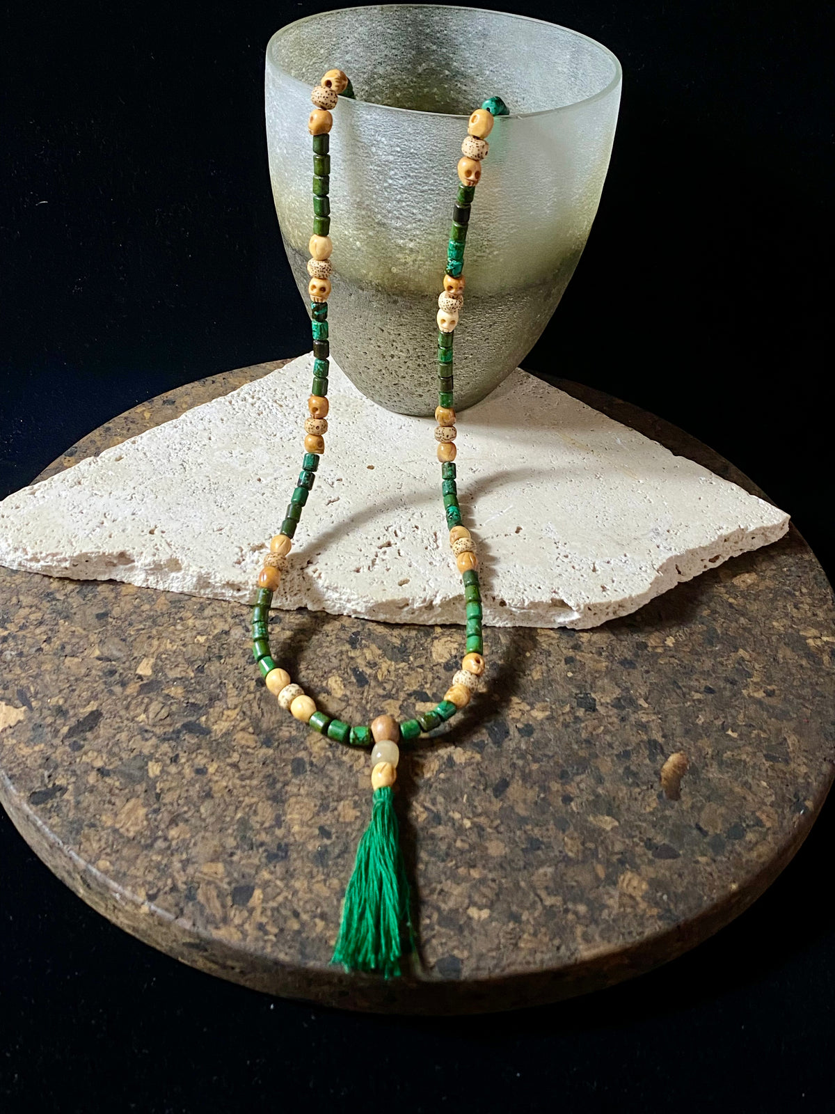 Our luxurious Buddhist mala contains 108 beads and has a beautifully organic look and feel. It's made from dark green turquoise beads, skull carved yak bone beads and lotus root beads, all finished with a sandalwood guru bead and a yak horn bead. Finished with a dark green tassel.