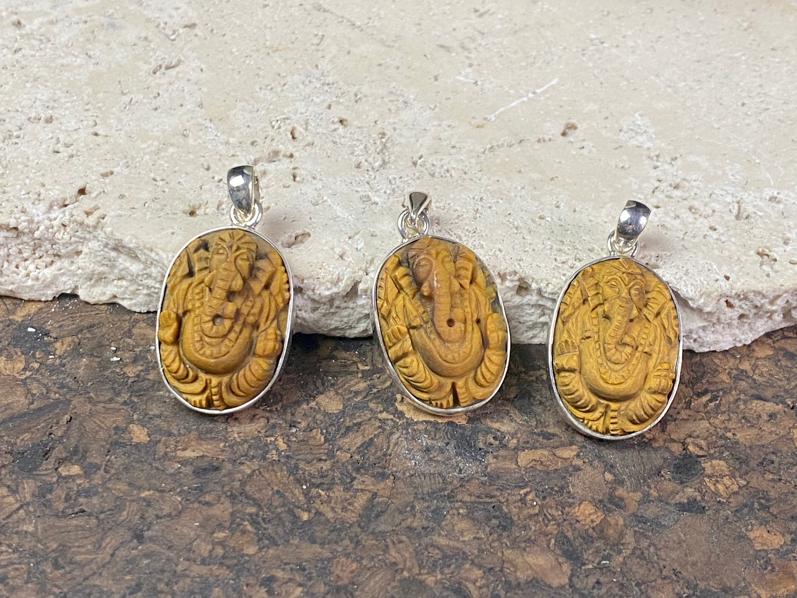 Hand carved Ganesh pendants, tigers eye with sterling silver mount and bail.  Dimensions 3.7 x 1.7 x 0.7 cm