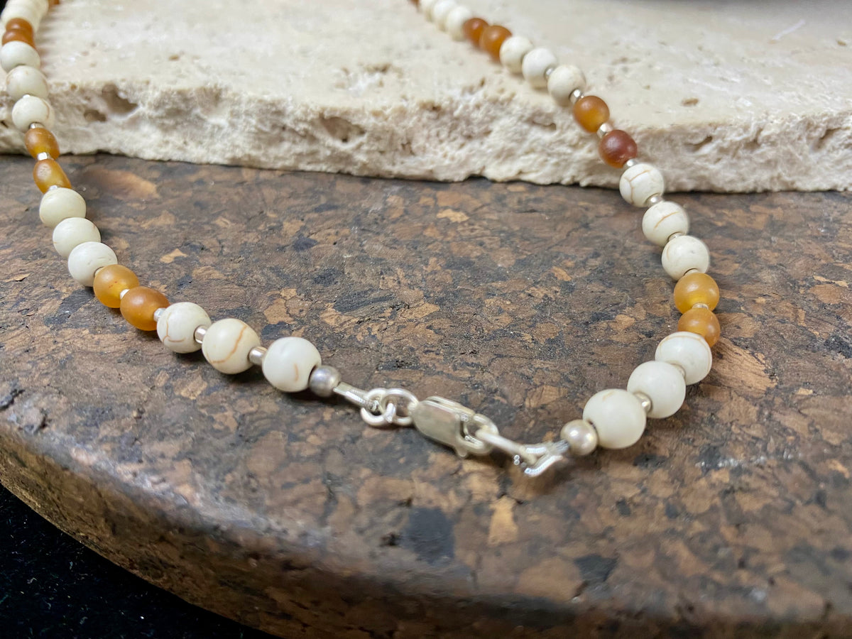 Our unique statement necklace features beautiful vintage beads from the Kashgar collection - turquoise centre bead, jasper beads from the Philippines, howlite beads, buffalo horn beads and  925 sterling silver detailing and lobster clasp. Length 45 cm.