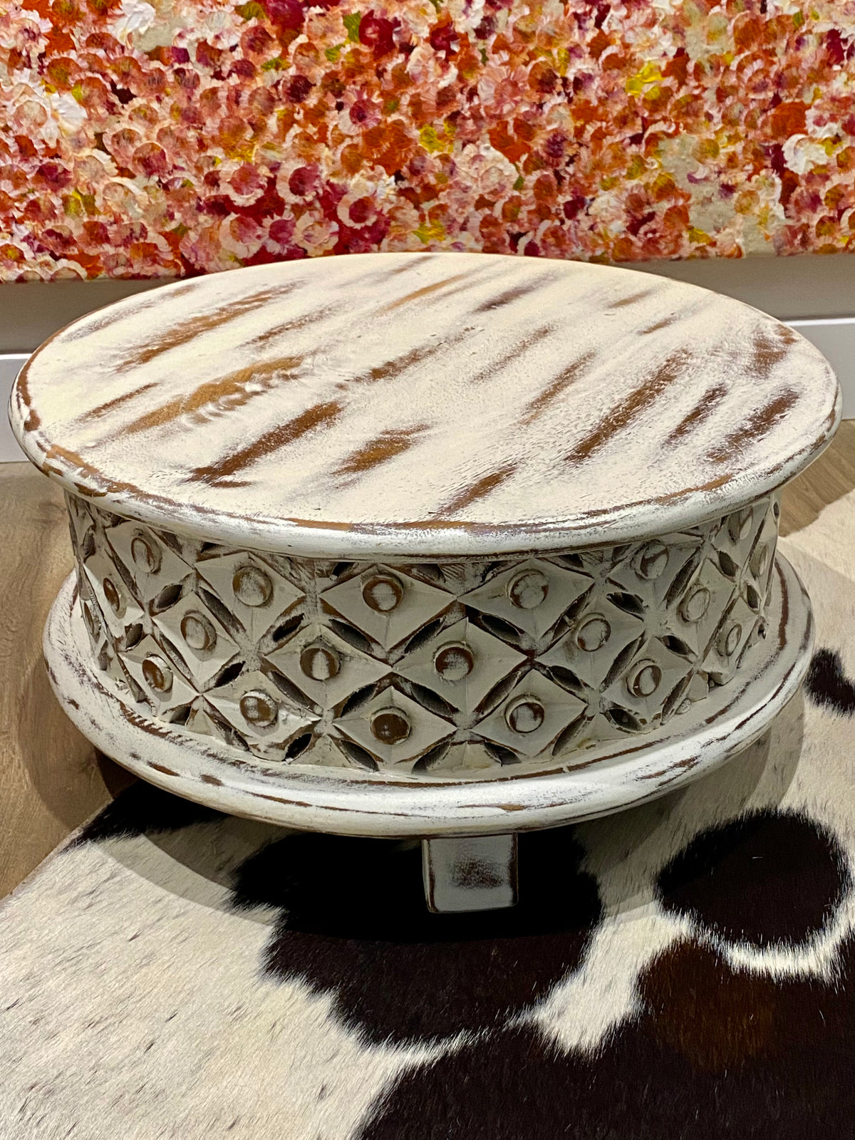 <p>Delightful, full wood small table with carved and pierced sides. Mango wood. Small enough to be used as a low bedside table, side table, pedestal or even on a table top.</p> <p>Measurements: diameter 44 cm, height 21.5 cm</p>