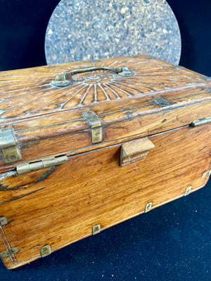A lovely old southern Indian cash box with carved top and original brass trim, handle and hinges. Fitted with two small shelves inside. Made from teak, this would make a lovely trinket box, key box, jewellery, watch or cufflink box Circa 1880 - 1920. Measurements: length 27.5 cm  x depth 19 cm, height 15 cm.