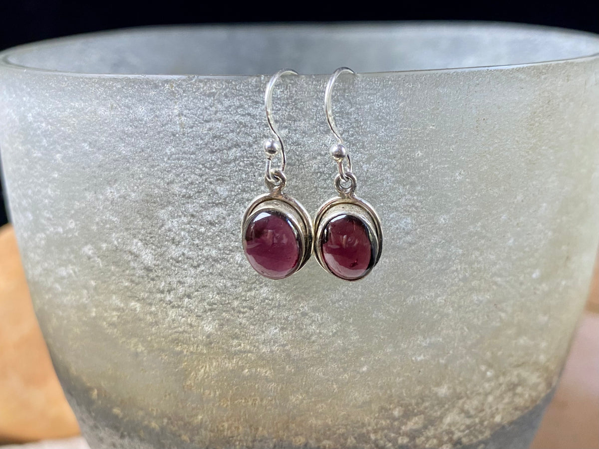Simply elegant oval earrings with a small shadow box bezel to show off the beauty of the natural cabochon gemstones. Sterling silver hooks complete the look. Our earrings are open-backed to allow the light of the stones to show through. Length including hook 2.5 cm