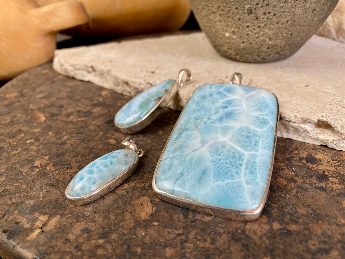 Larimar stone pendants set in sterling silver. Each pendant is unique, cut and mounted to showcase the beauty of the individual stones.