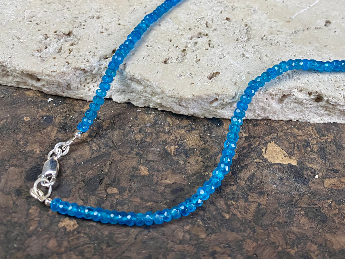 Short dark blue apatite necklace featuring graduated faceted apatite beads finished with a sterling silver lobster clasp. This is a lovely statement necklace that matches any skin tone or clothing. These stone are natural and not heat treated Measurements: 39.7 cm total length 