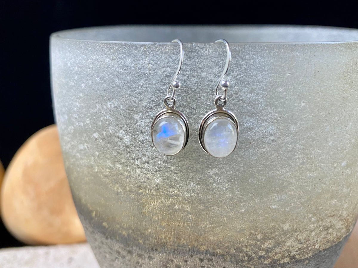 Simply elegant oval earrings with a small shadow box bezel to show off the beauty of the natural cabochon gemstones. Sterling silver hooks complete the look. Our earrings are open-backed to allow the light of the stones to show through. Length including hook 2.5 cm