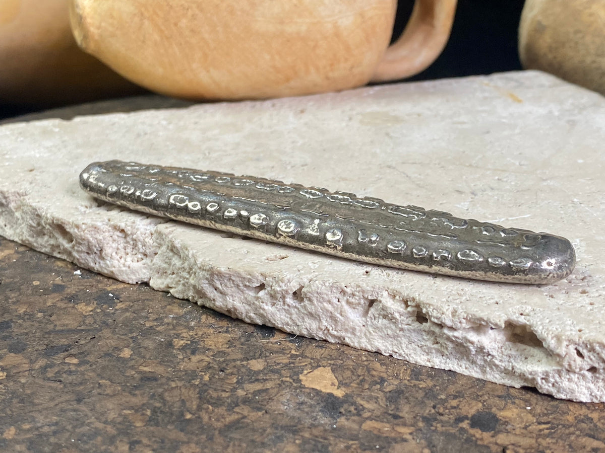 Silver 1.5 Tamlung Lat (short for talat, or currency), often called tiger tongue money, with 3 na (snake) marks. Circa 1591-1707. Laos Vientiane.  This is a hand poured silver ingot with its original patina. Length 11.8 cm