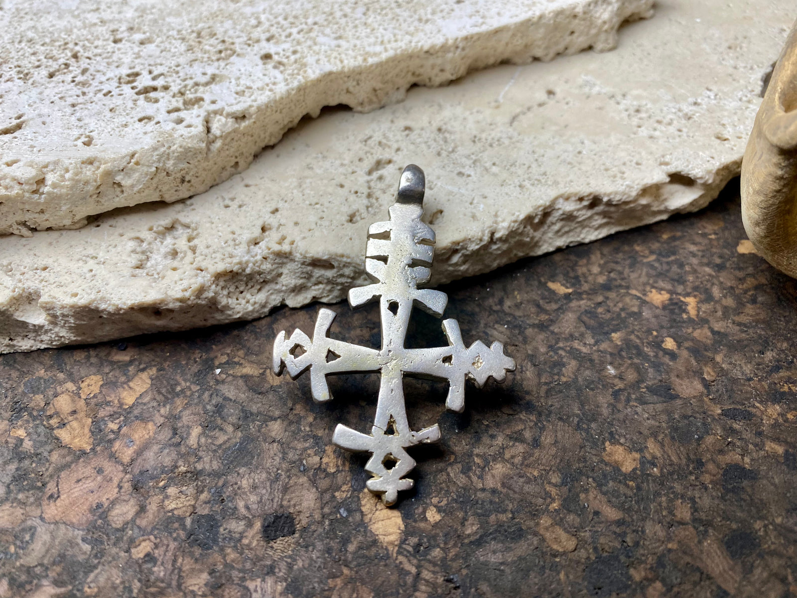 Mid 20th century Ethiopian silver crucifix. This may have been cut from a Marie Therese silver thaler, as the antique ones always are, however I believe that the style is more recent. Tests as silver. Plain on front side, plain back. Some wear at the head of the bail commensurate with its age. A wearable and collectable piece of jewellery.  Measurements: length including bail 6 cm