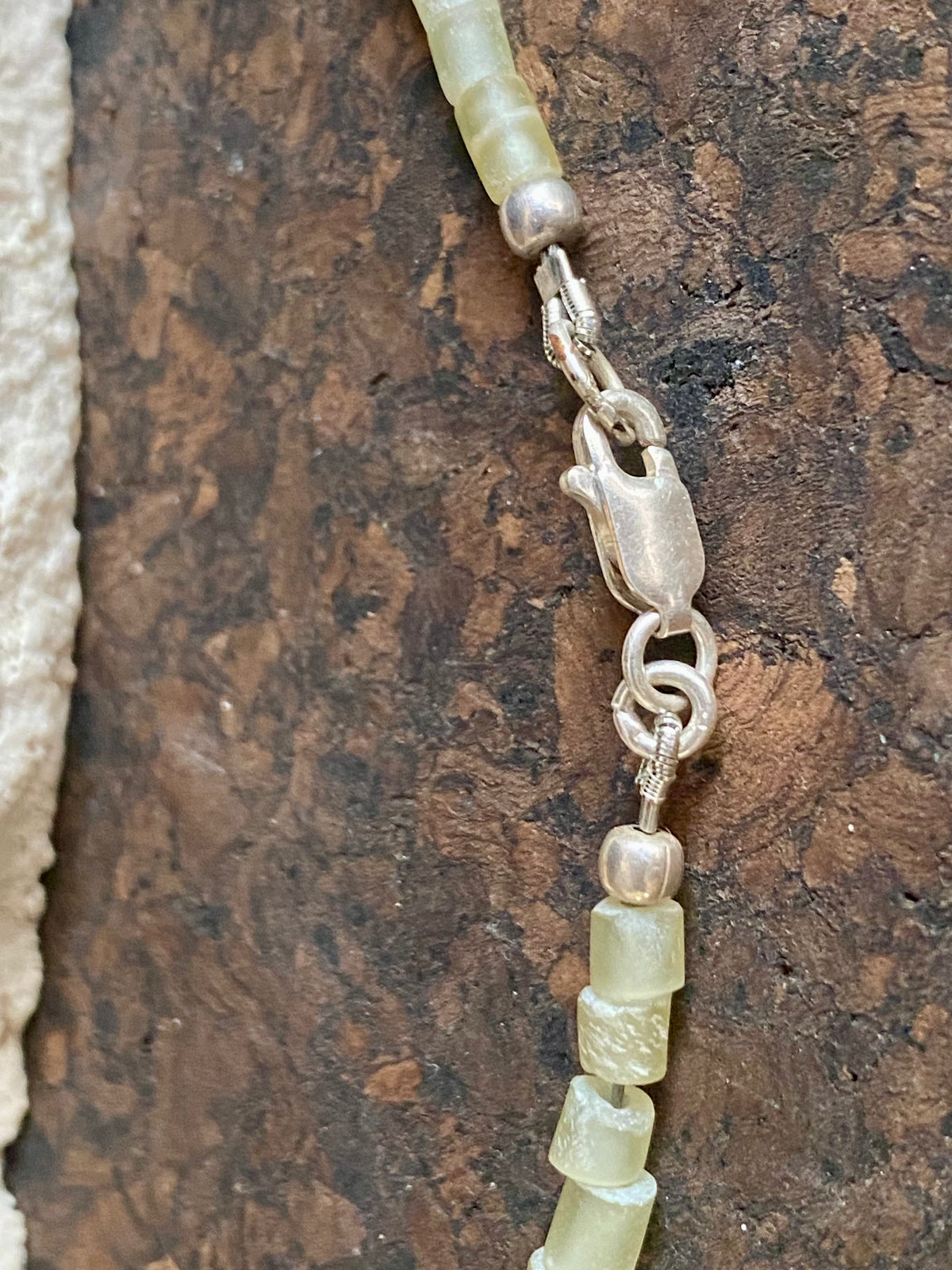 This unique choker features beautiful vintage beads from the Kashgar collection - blue green turquoise centre bead, Ethiopian opal, Bone beads from Burma, Pale green chrysoprase beads, Green serpentine tube beads from Afghanistan and 925 sterling silver detailing and lobster clasp. Length 40.5 cm