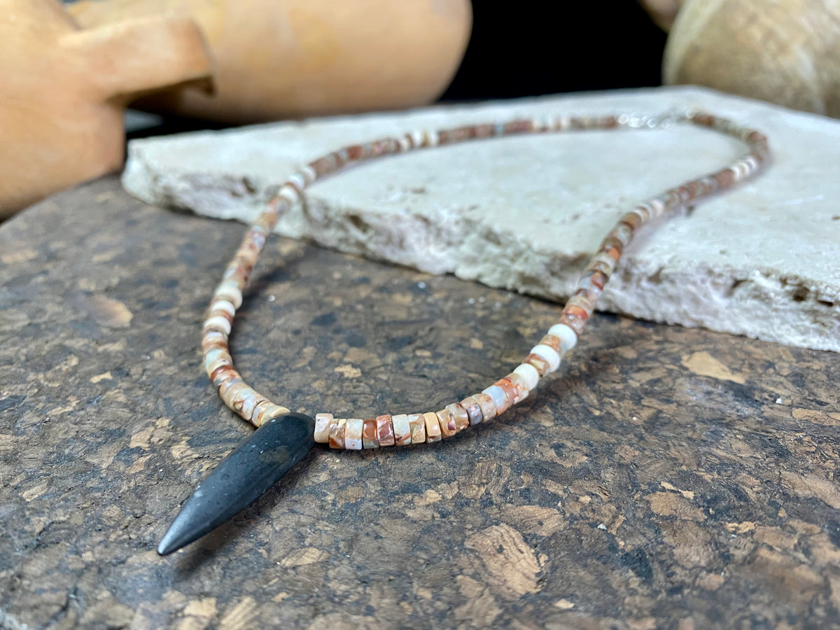 This unique necklace is made from heshi amazonite quartz druzy beads, highlighted with Kachin Burmese shell beads and a pendant made from unpolished onyx. Finished with sterling silver findings and hook clasp. Our necklace will look great on either men or women. Measurements: length including clasp 43.5 cm (17”)
