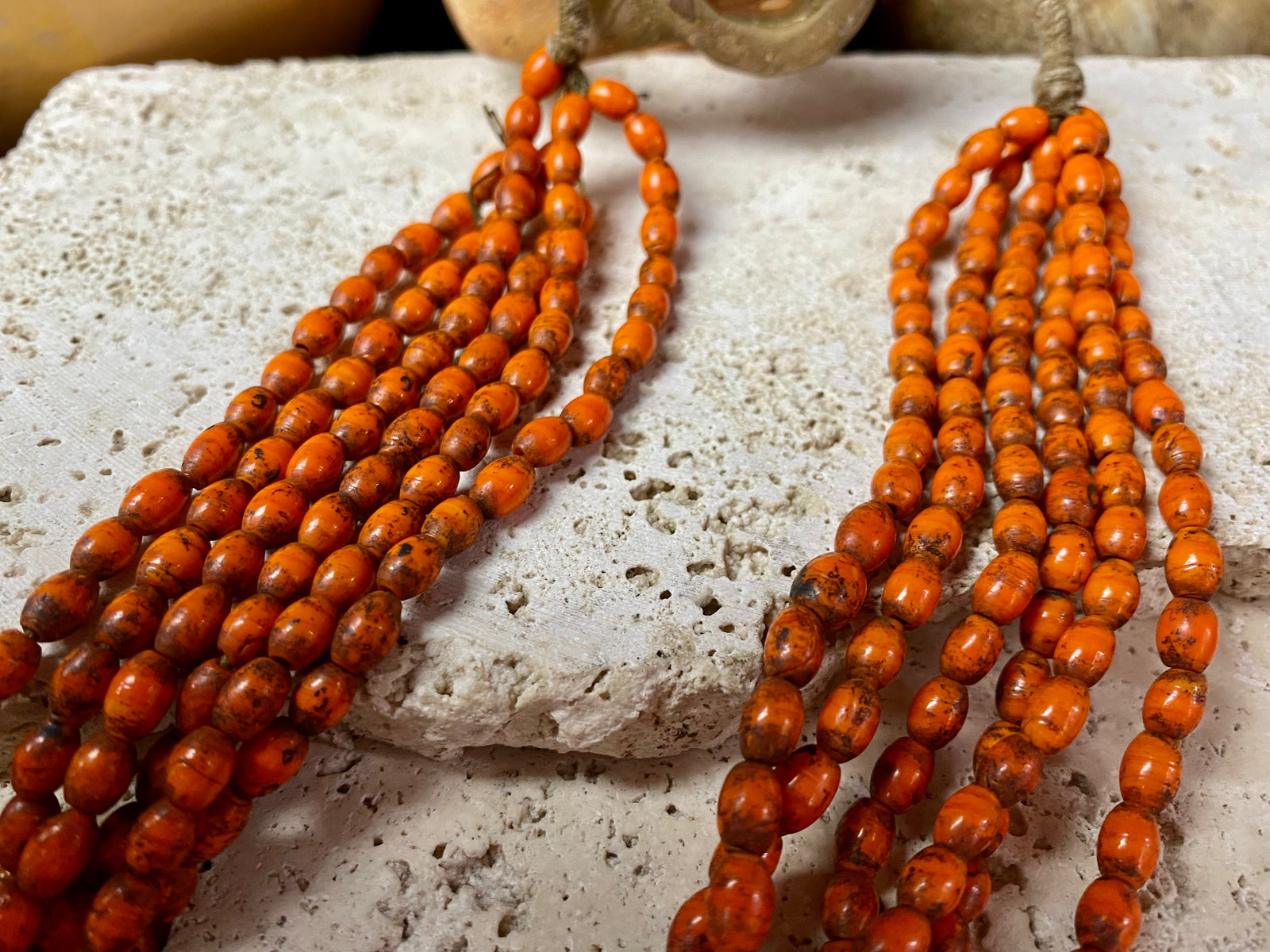 Vintage Naga long multistrand necklace made up of old ceramic beads with wrapped cotton ends and a coin button as fastener.  Measurements: 74 cm length