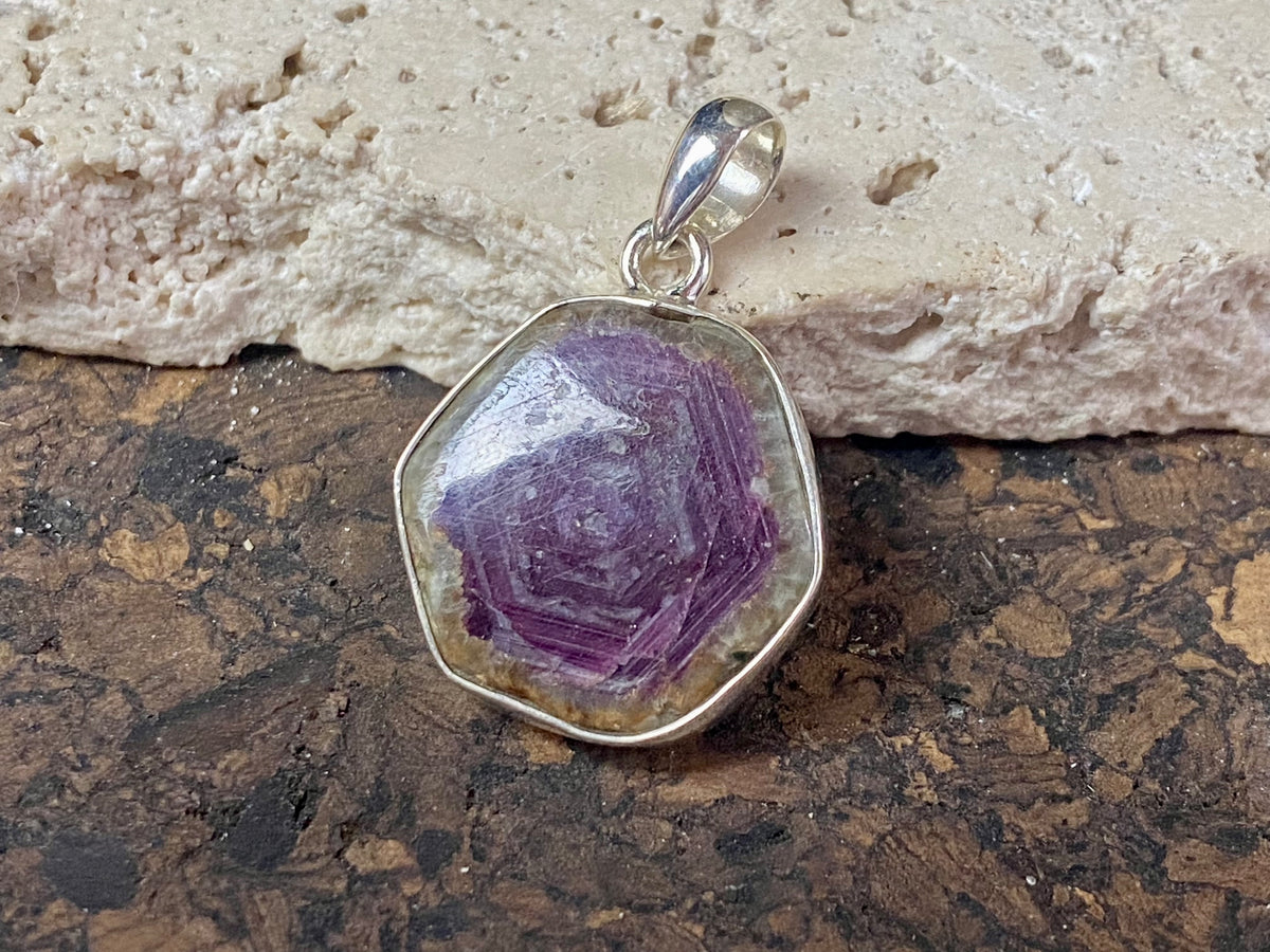 Trapiche ruby pendant with the very desirable hexagonal growth pattern, surrounded by a border of natural quartz and set in sterling silver. Height including bail 3.3 cm, width 2.2 cm