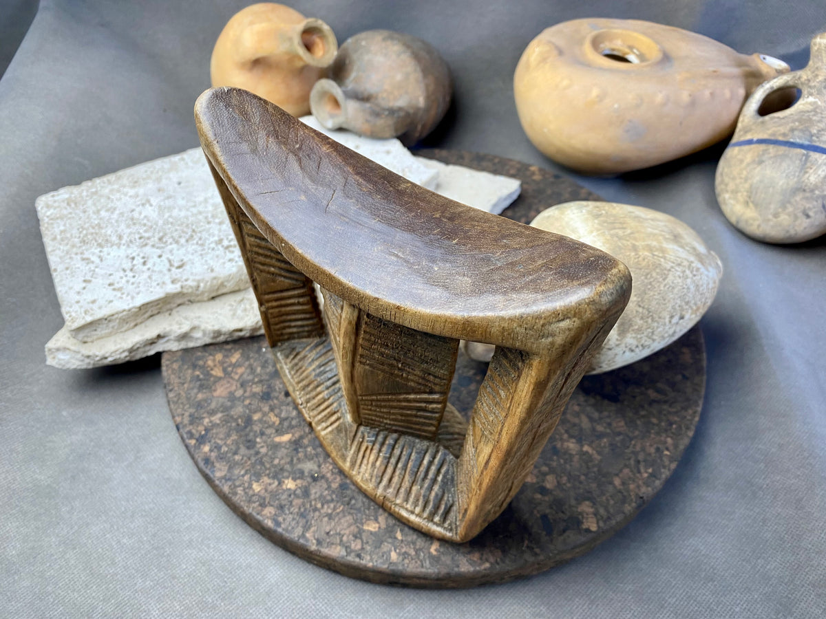 Old Oromo tribe wooden headrest from Ethiopia. Carved from a single piece of wood. Pre 1950. The patina and wear on this piece are appropriate to its age. In particular, note that the upper surface is darkened from use and the leading front edge is both lower than the rear edge and is also smooth from use.