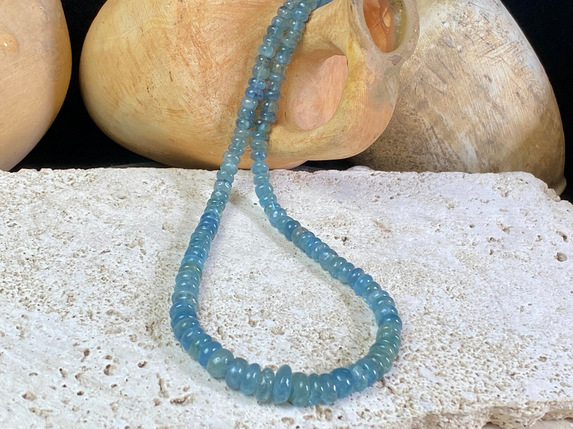 Natural aquamarine necklace featuring rondel cut graduated aquamarine. Sterling silver hook and ring clasp. The aquamarine beads are matched, graduated, 100% natural, of a deep cloudy sea blue. Measurements: 41.5 cm