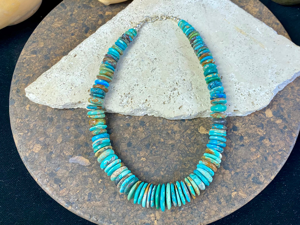 Stunning bright blue Arizona turquoise necklace featuring graduated disks of Arizona turquoise finished with sterling silver. Length 47.5 cm