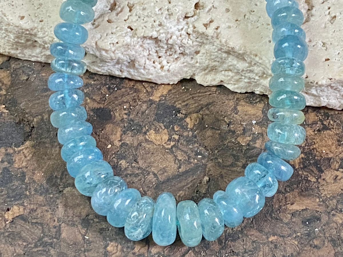 Natural aquamarine necklace featuring rondel cut graduated aquamarine. Sterling silver hook and ring clasp. The aquamarine beads are matched, graduated, 100% natural, of a deep cloudy sea blue. Measurements: 41.5 cm