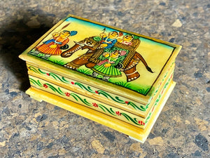 Small perfectly formed trinket or pill boxes, hand crafted from polished hand shaped panels of camel bone, which are then exquisitely hand painted with scenes of elephants. Set on small feet for real elegance. Length  7.5 x 4.5 cm, height 3 cm