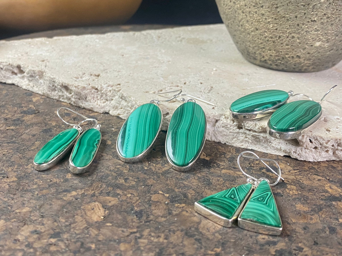 Our elegant earrings feature perfectly matched malachite cabochons set in sterling silver bezels. Finished with sterling silver hooks.