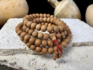 Women or men’s Buddhist mala necklace. Natural sandalwood, 108 beads. Total length 96 cm. Sandalwood beads are 8 mm diameter
