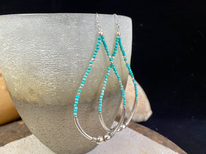 Hand crafted using tiny natural turquoise beads and 925 sterling silver. These very long earrings are unique.  Natural Arizona turquoise Sterling silver hooks and bead detailing Light and easy to wear  Measurement: total height including hook approximately 9.5 cm (3.75 in)