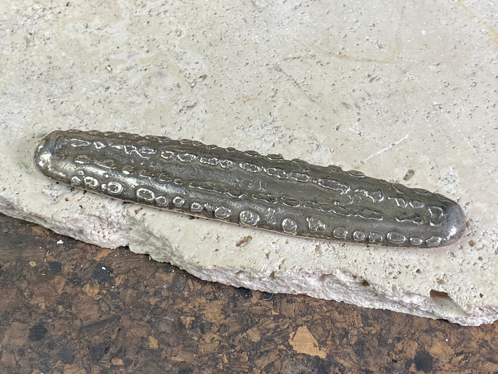 Silver 1.5 Tamlung Lat (short for talat, or currency), often called tiger tongue money, with 3 na (snake) marks. Circa 1591-1707. Laos Vientiane.  This is a hand poured silver ingot with its original patina. Length 11.8 cm