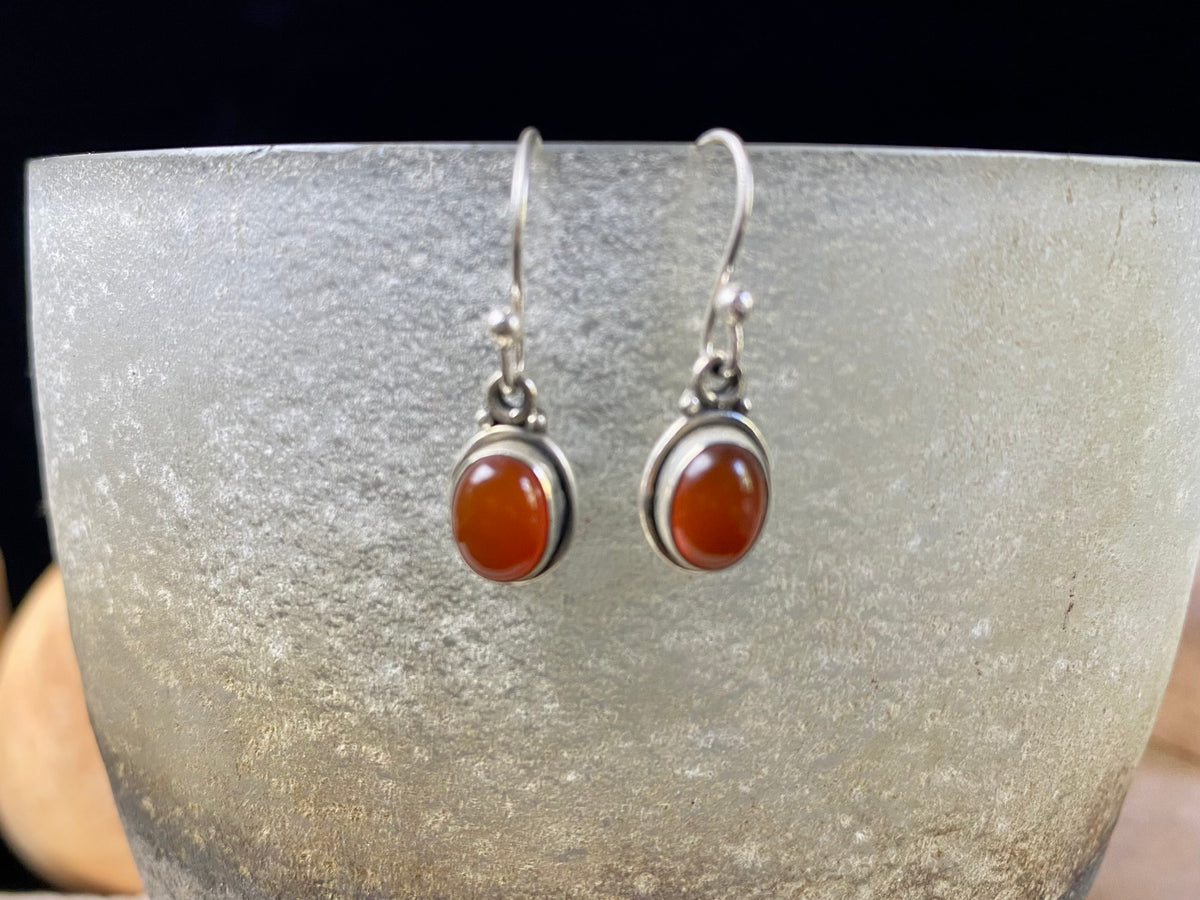 Simply elegant oval earrings with a small shadow box bezel to show off the beauty of the natural cabochon gemstones. Sterling silver hooks complete the look. Our earrings are open-backed to allow the light of the stones to show through. Length including hook 2.5 cm