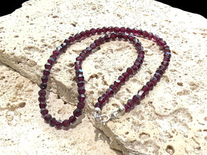 Simple garnet choker featuring facet cut garnet beads and sterling silver findings. Length 38 cm.