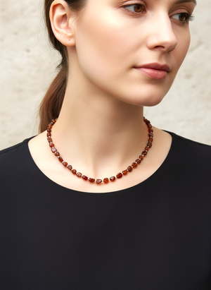 Cinnamon coloured, graduated hessonite garnet boulder beads, highlighted with sterling silver, finished with a silver hook clasp. Length 42 cm