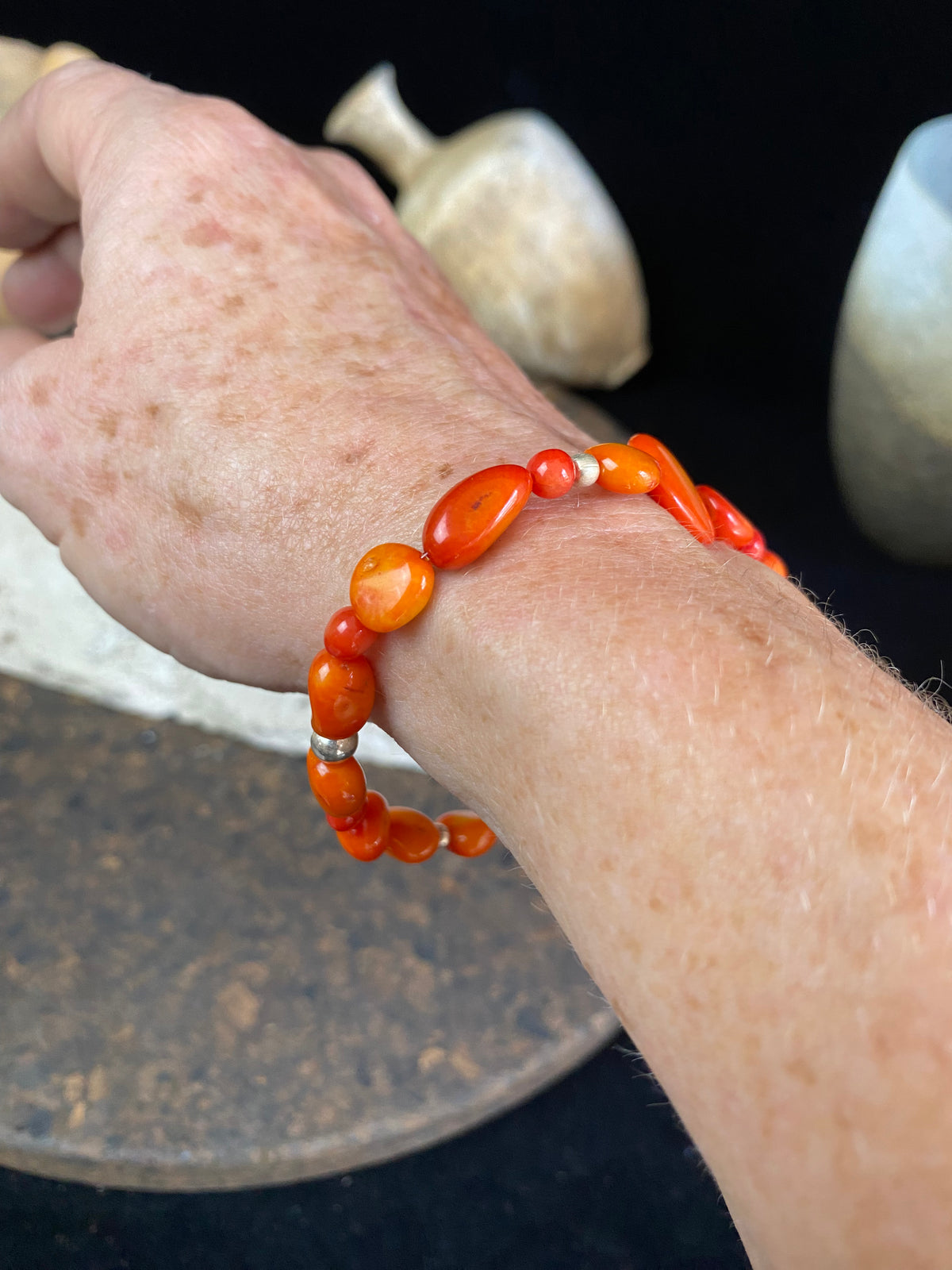 Charming bracelet made from Pacific deep sea bamboo coral in dark and light orange tones, finished with sterling silver. Elasticised cord for a seamless look.