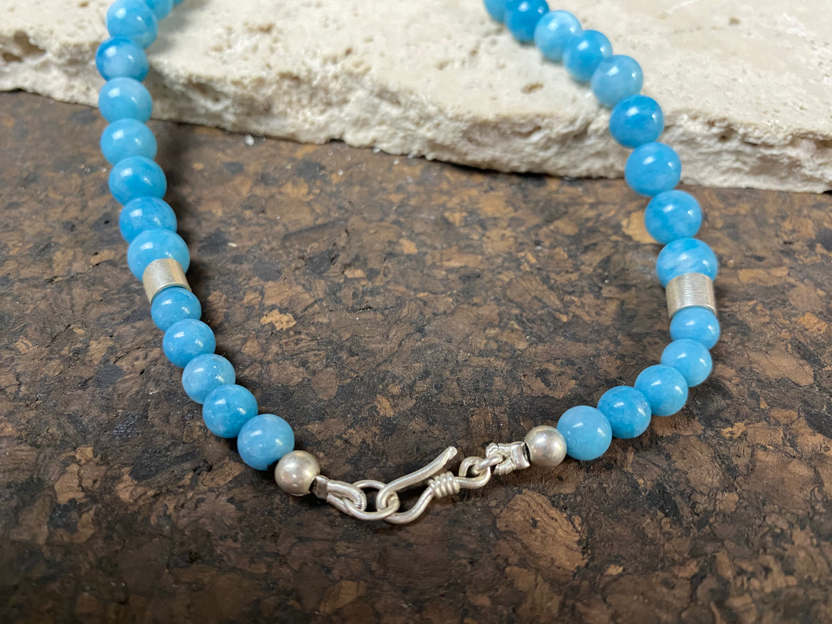 Graduated blue chalcedony necklace with sterling silver bead detailing and a sterling silver hook clasp. Measurements: 41.5 length including hook, diameter of beads 8, 6 and 4 mm