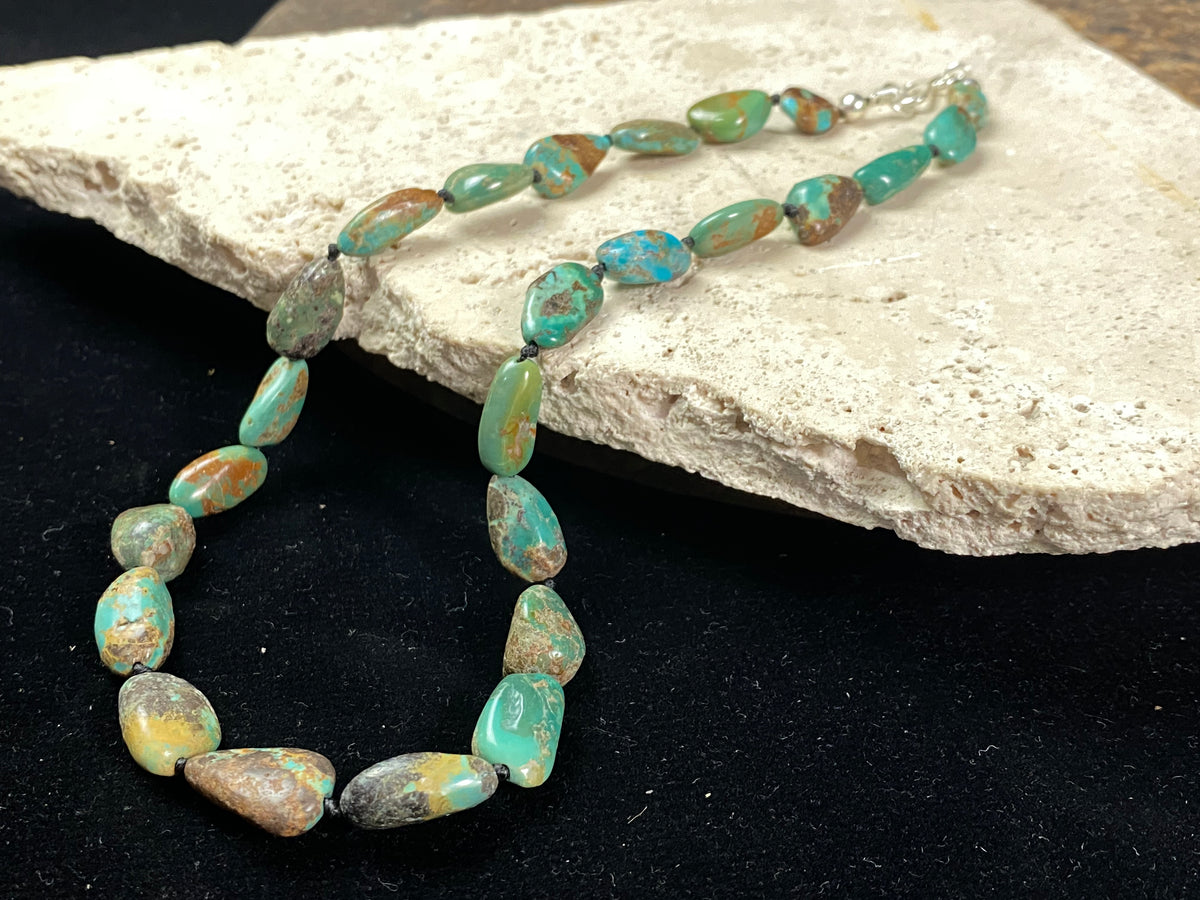 Tibetan turquoise necklace. Knotted between each bead and finished with sterling silver clasp. length 46.5 cm