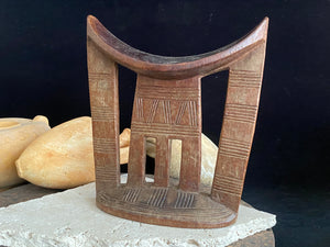 Old kambatta tribe wooden headrest from Ethiopia. Carved from a single piece of wood. Pre 1950. The patina and wear on this piece are appropriate to its age. In particular the upper surface is darkened from use. Measurements: height 18.5 cm