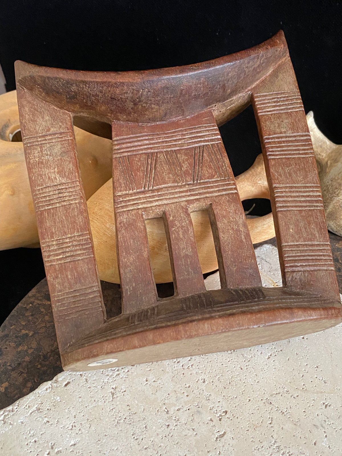Old kambatta tribe wooden headrest from Ethiopia. Carved from a single piece of wood. Pre 1950. The patina and wear on this piece are appropriate to its age. In particular the upper surface is darkened from use. Measurements: height 18.5 cm