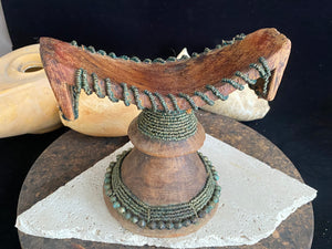 Very old Oromo wooden headrest from Ethiopia. Carved from a single piece of wood, heavily beaded with green oxidation. Pre 1950. The patina and wear on this piece are appropriate to its age.  Measurements: height 16 cm, width 18 cm
