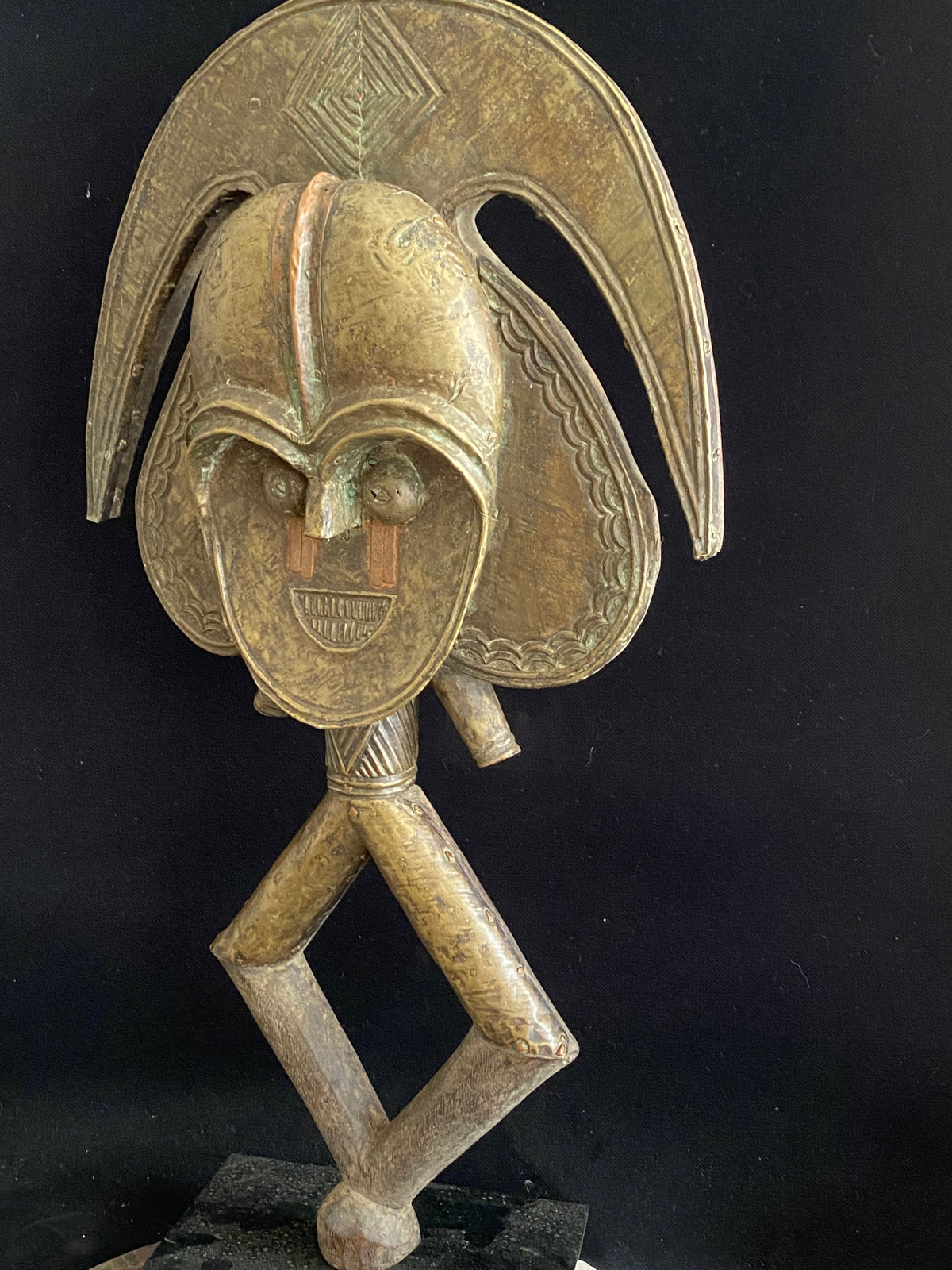Mbulu-ngulu or funerary reliquary protective figure. Kota people, Gabon, West Africa. Mid to late 20th century. Wood with copper and brass decorative overlay. Height 54 cm, width at widest point 30 cm.