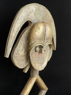Mbulu-ngulu or funerary reliquary protective figure. Kota people, Gabon, West Africa. Mid to late 20th century. Wood with copper and brass decorative overlay. Height 54 cm, width at widest point 30 cm.
