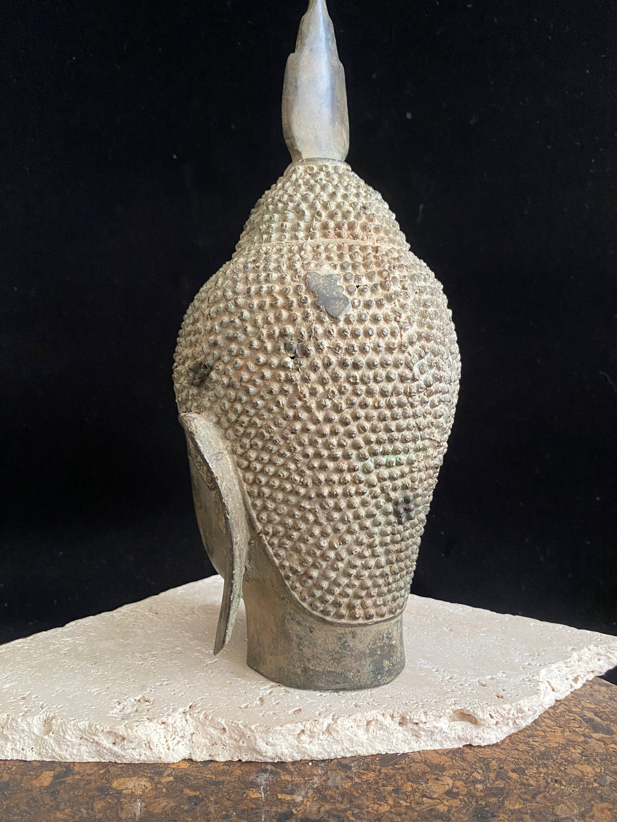 Thai Buddha head. Serene expression, hair topped with the flamed Ushnisha. Sukhothai style, bronze, mid 20th century. A softly contoured face with the bow shaped lips, prominent ears, arched eyebrows and aristocratic features typical of this style of work. Measurements: height 25 cm, width 11 cm