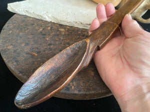 Very old wood serving spoon or ladle. Hand carved fine grained wood. From northern Ethiopia.This spoon has a lovely worn patina commensurate with its age. The spoon end is darkened from use in or near an open fire. Early 20th century. Length 44.5 cm