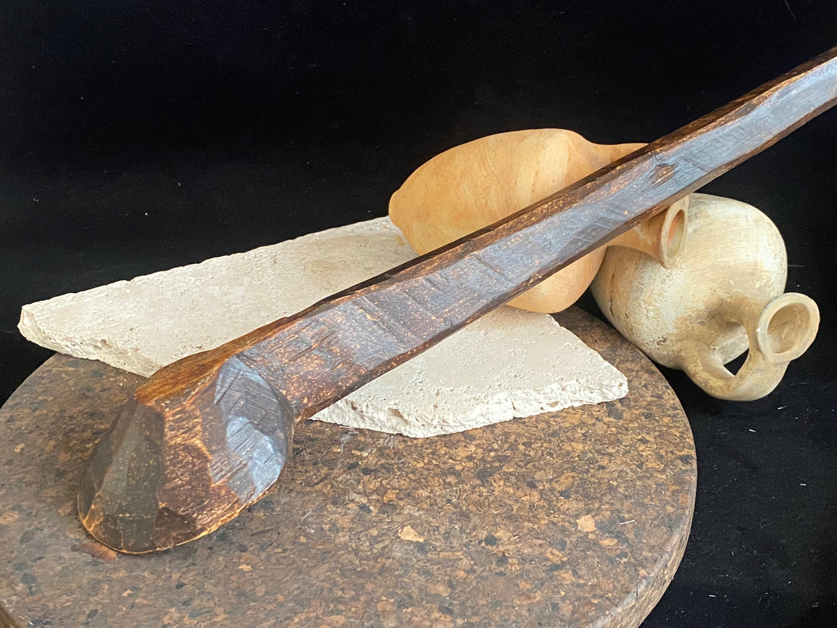 Vintage wood serving ladle. Hand carved wood. From northern India. This spoon is drilled and can be hung from its leather strap. This spoon has a lovely worn patina commensurate with its age. Each piece is hand carved, unique and artisan made. Length 58 cm, width of spoon 8 cm.
