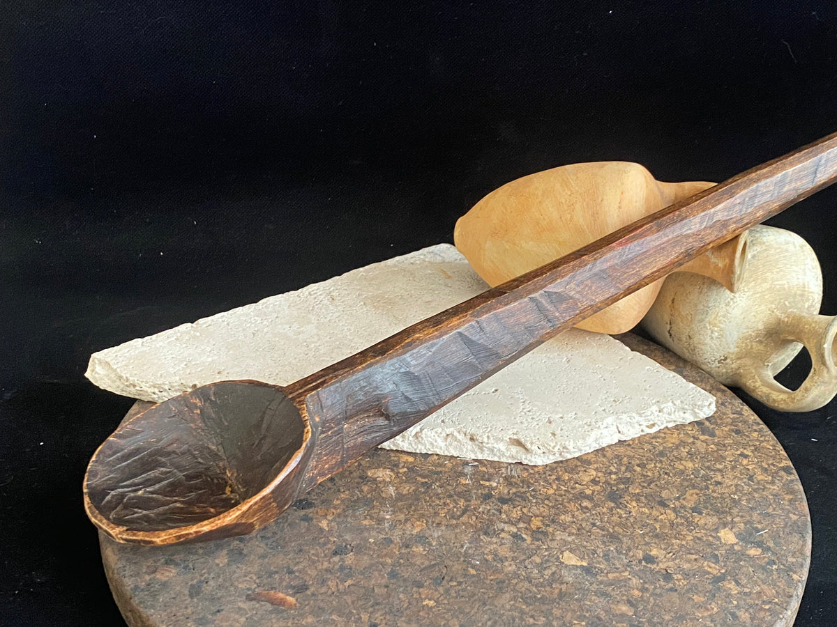 Vintage wood serving ladle. Hand carved wood. From northern India. This spoon is drilled and can be hung from its leather strap. This spoon has a lovely worn patina commensurate with its age. Each piece is hand carved, unique and artisan made. Length 58 cm, width of spoon 8 cm.