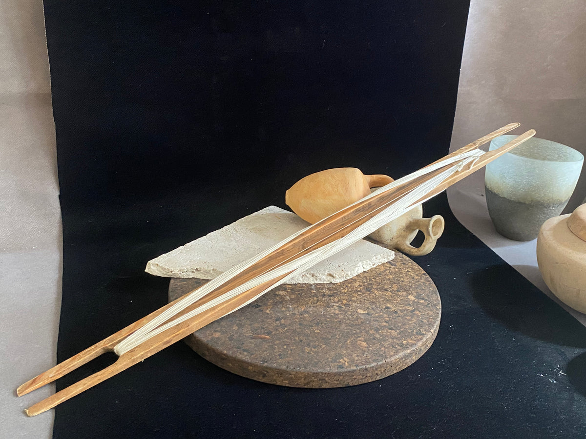 This unusual item is used to mend fishing nets. It is a very long, hand carved wood "needle" or shuttle with string or rope looped over it. If you're looking for unusual homewares or decorative items with a difference, or even a prop for a photo shoot, play or film set, this is it. Length 69 cm, width 4.5 cm