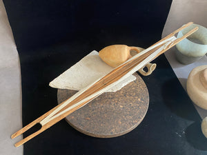 This unusual item is used to mend fishing nets. It is a very long, hand carved wood "needle" or shuttle with string or rope looped over it. If you're looking for unusual homewares or decorative items with a difference, or even a prop for a photo shoot, play or film set, this is it. Length 69 cm, width 4.5 cm