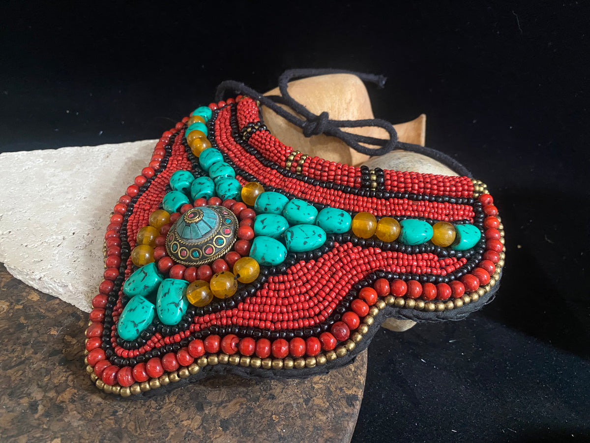 Traditional bib or pectoral beaded necklace, with a multitude of colourful ceramic and resin stones sewn onto a stiff fabric background and tied around the neck with a cord. Sikkim jewellery, India