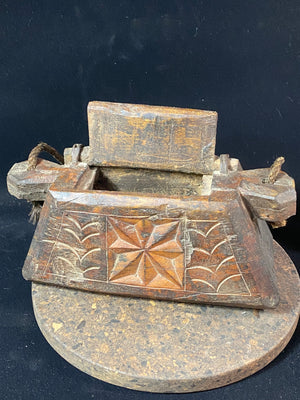 These oddly shaped pots were used to store mustard oil, ghee, yak butter and lantern oil. This very heavy example weighs 2.4 kg and is carved from solid teak. Hand beaten iron hinges. Traces of oil encrustation still inside. Age 1900-1920 or earlier. Measurements: width 29 cm, depth 12 cm, height 13.5 cm