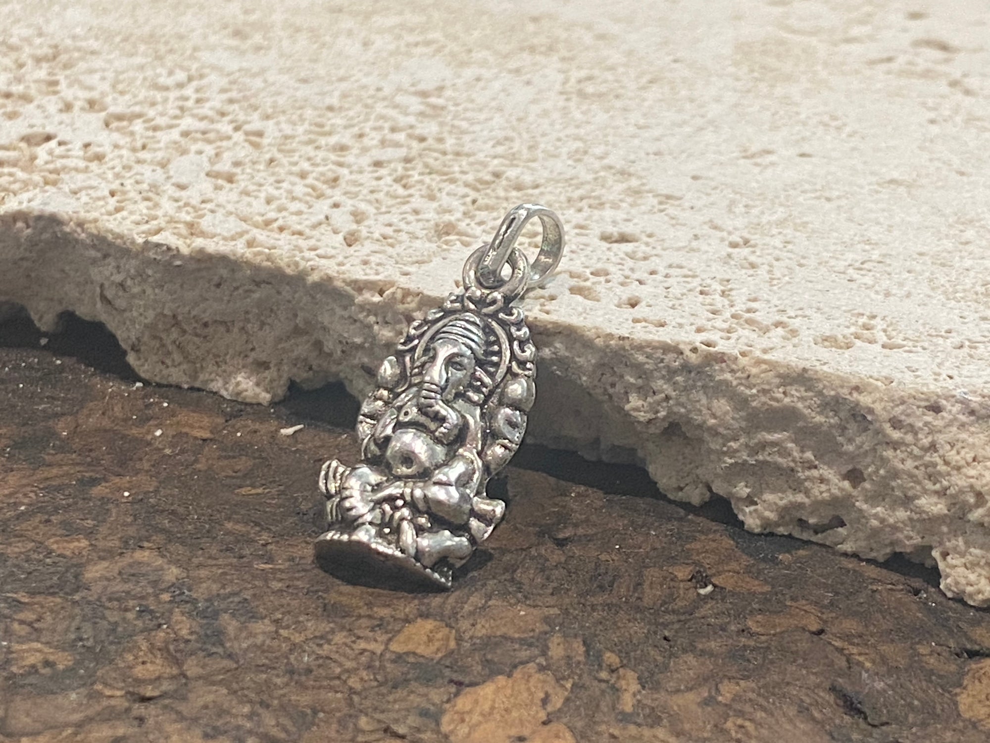 Sterling silver pendant featuring an elegant and finely detailed image of Lord Ganesha. A generous bail allows this pendant to be worn on a large chain or cord. This is a unisex pendant. Sterling silver, from India Measurements: 3 cm height including bail, width 1.2 cm