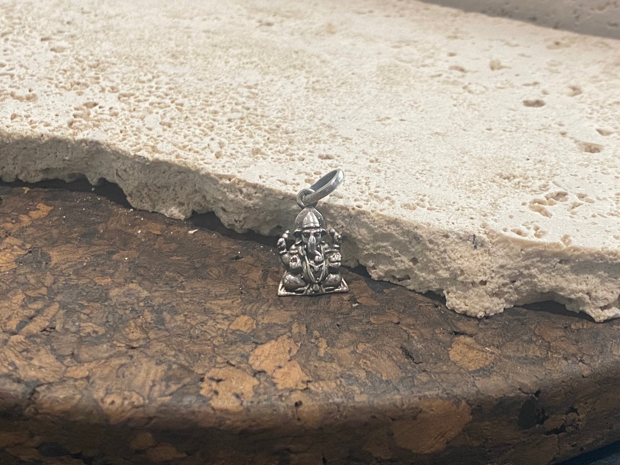 Our smallest Lord Ganesha silver pendant. A generous bail allows this pendant to be worn on a large chain or cord. This is a unisex pendant. Sterling silver, from India Measurements: 2.2 cm height including bail, width 1 cm