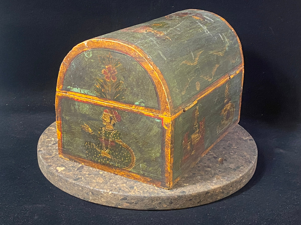 A lovely old painted Indian chest with domed top in the shape of a treasure chest. Painted on all sides with images of Indian lords and ladies. Made from teak. This would make a lovely trinket box, key box, jewellery, watch or cufflink box. Circa 1940. Measurements: length 24 cm x depth 15.5 cm, height 16 cm